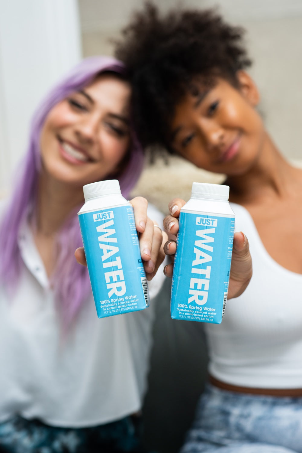 GIRLS HOLDING A JUST WATER CANS