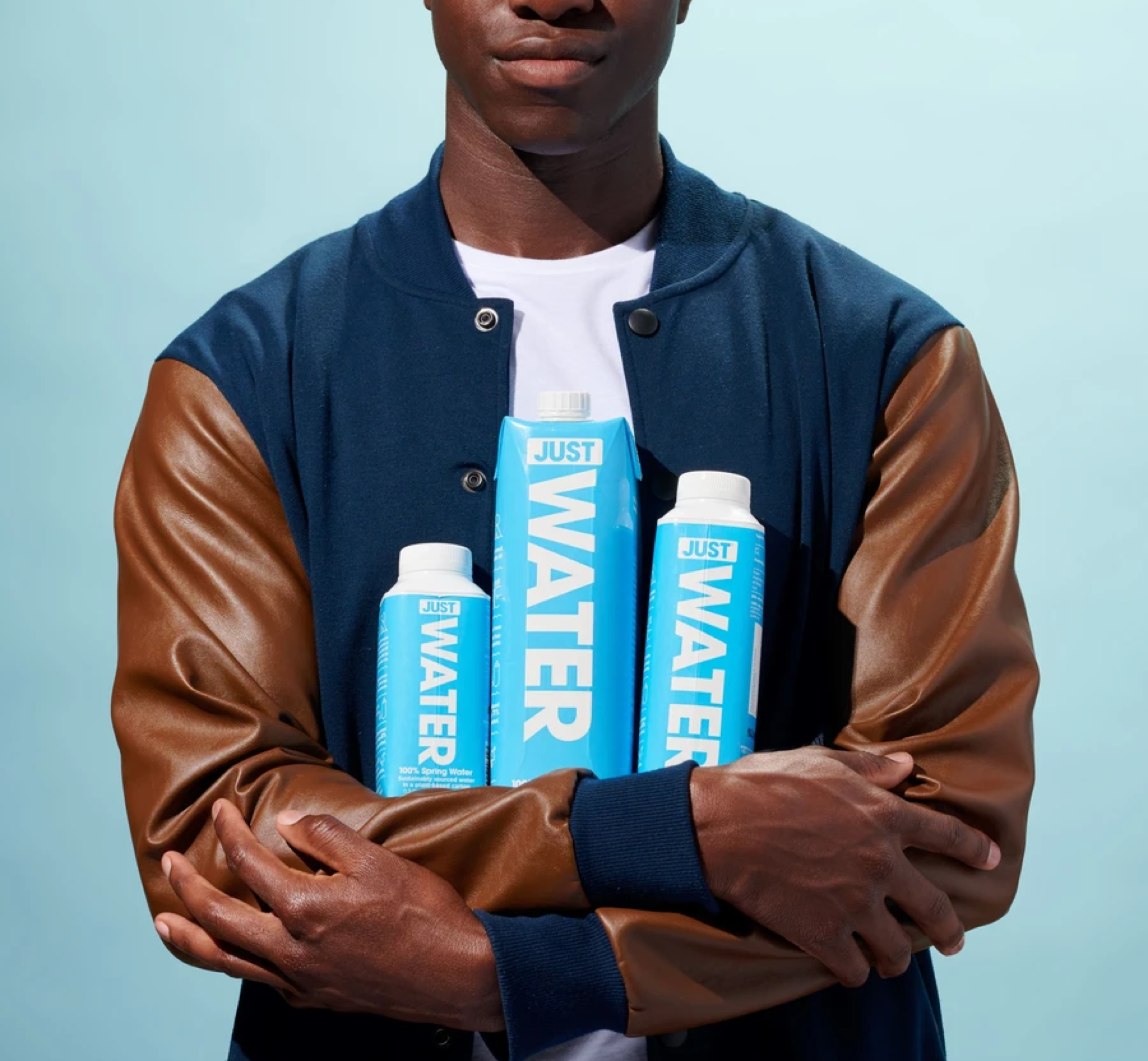 JUST Water coupons, MEN HOLDING THREE CARTON OF JUST WATER